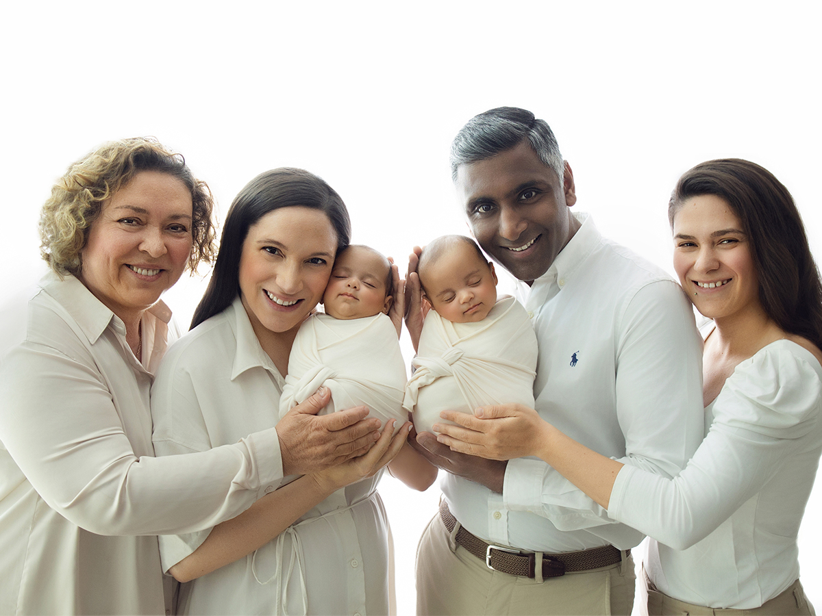 Grandparents and parents holding newborn twins during an extended family photography session in Essex.